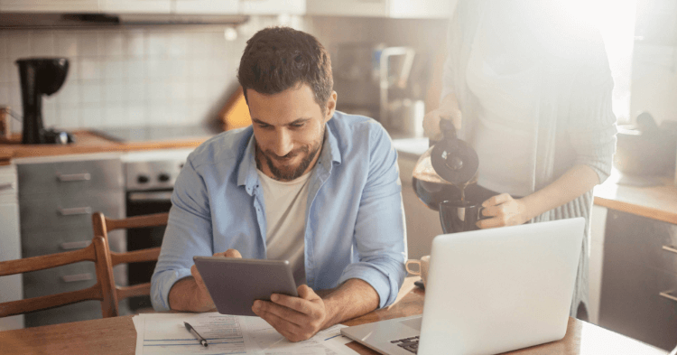Man researching debt consolidation on computer.