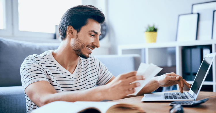 Man reviewing his finances on a laptop