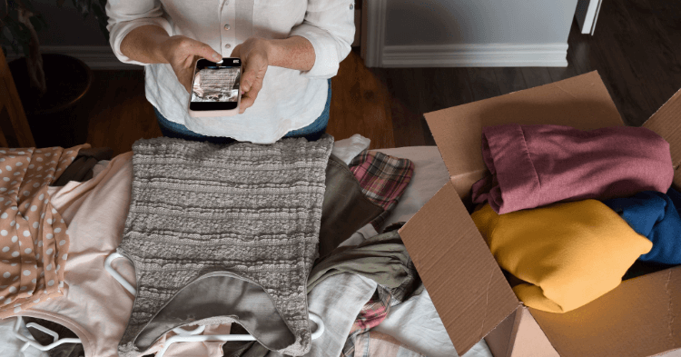 Woman taking a picture of clothing with her smartphone.